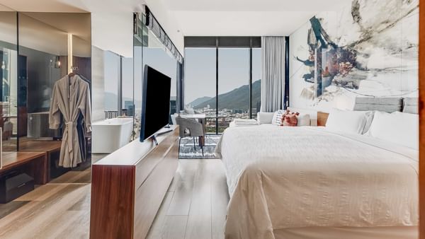 King bed and TV in living area with mountain view of Deluxe Room Dog Friendly at Live Aqua Monterrey