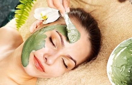 A girl having facial in the Heliconia Spa at Fiesta Resort