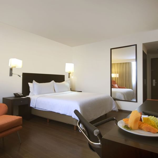 King bed with furniture in Superior Room at Fiesta Inn