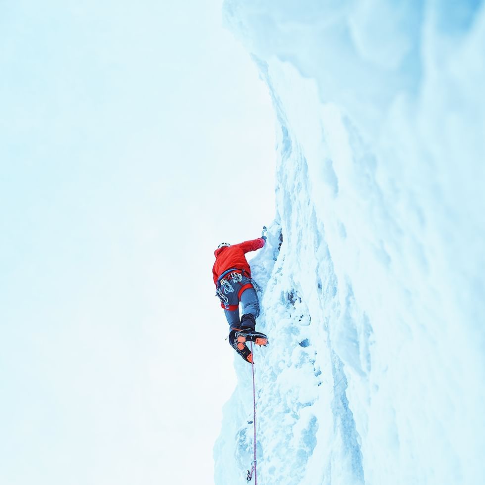 A man doing ice climbing near Falkensteiner Hotels