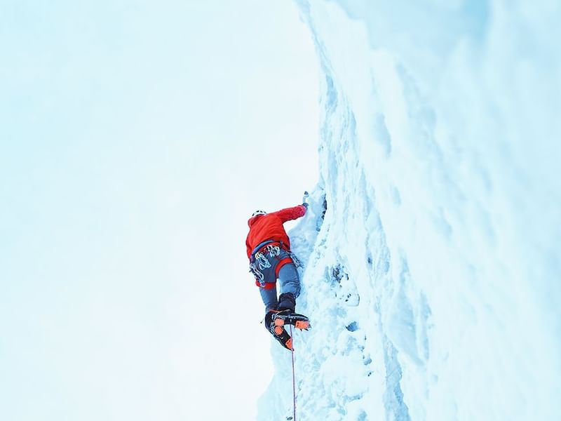 A man doing ice climbing near Falkensteiner Hotels