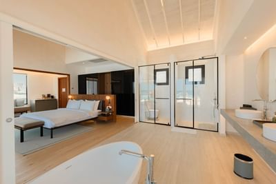 Modern Water Pool Villas room at Ananea Madivaru Maldives with a king bed, walk-in shower, bathtub, and stylish decor