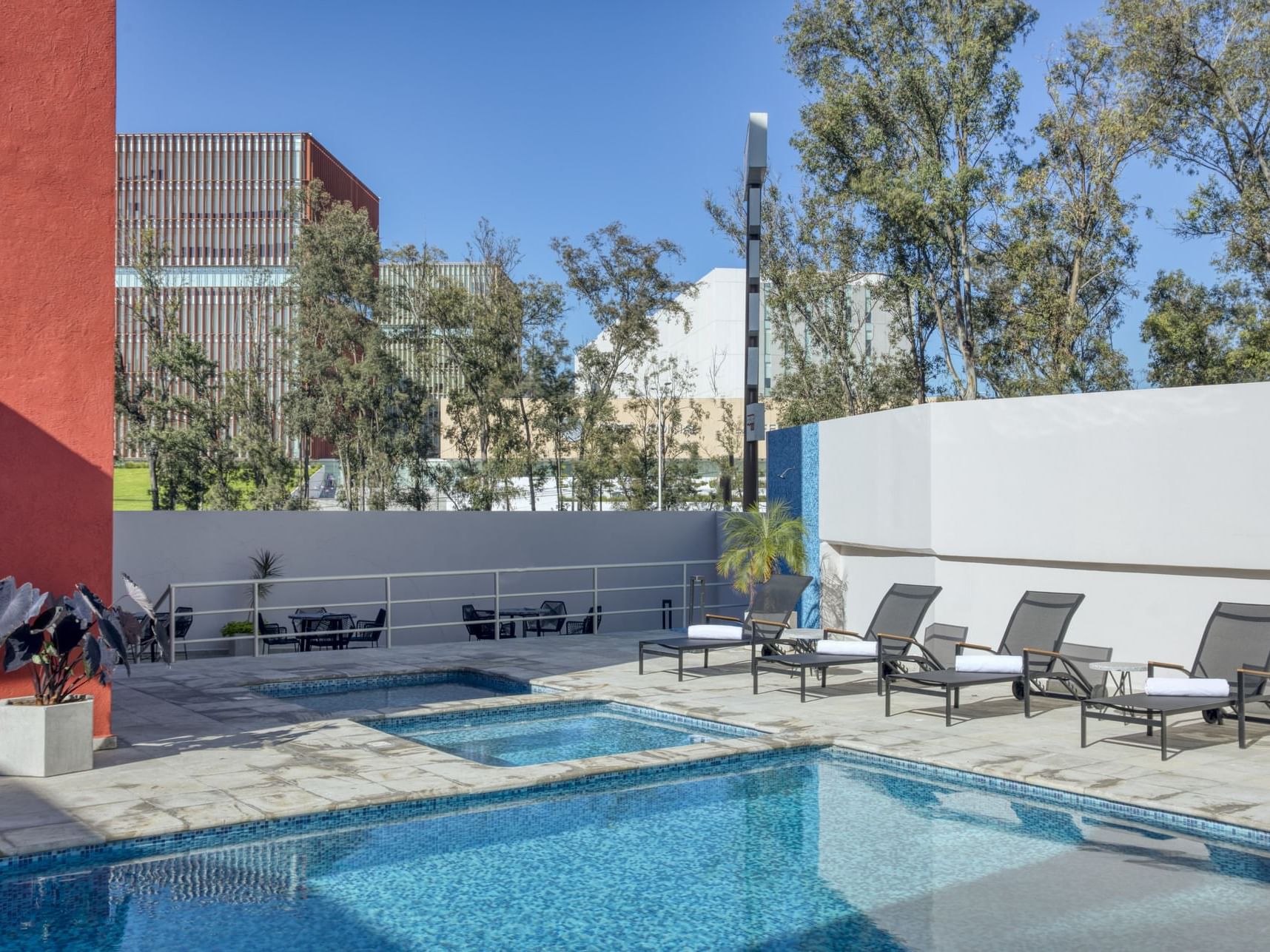 Outdoor swimming pool with pool beds at Fiesta Inn Hotels