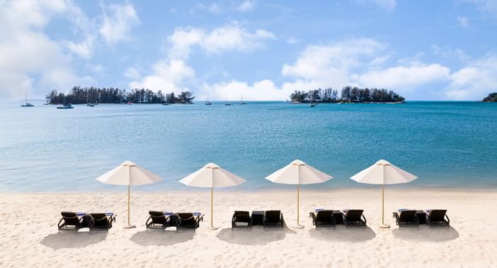 Sunbeds with umbrella's on the beach at Danna Langkawi