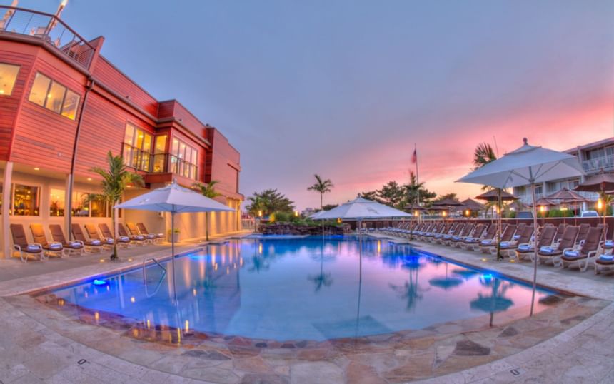 The outdoor heated pool at sunset at our Avalon NJ hotel