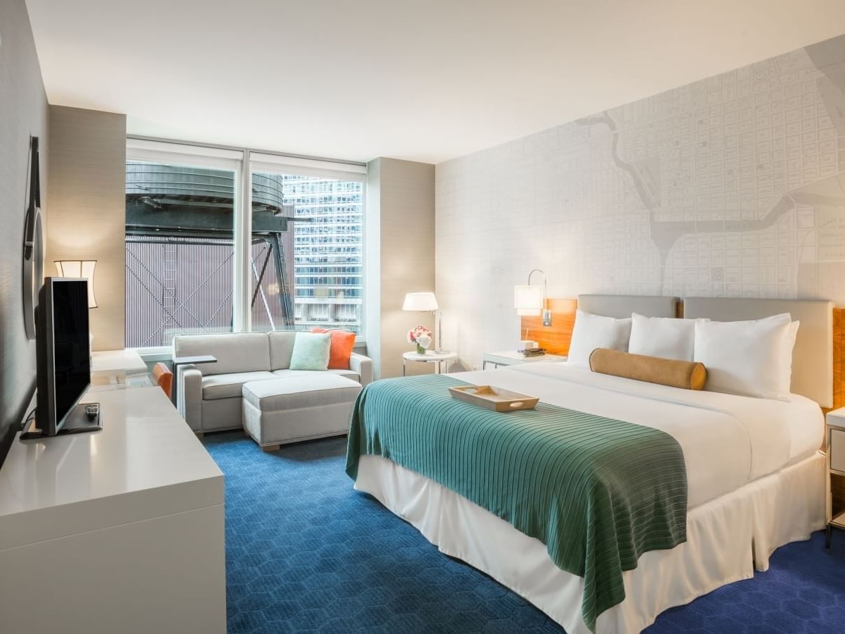 Bed, sofa & a TV in Accessible King Room at Kinzie Hotel