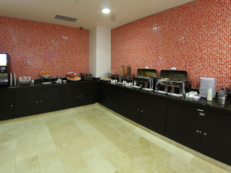 A buffet display in a breakfast room at One Hotels