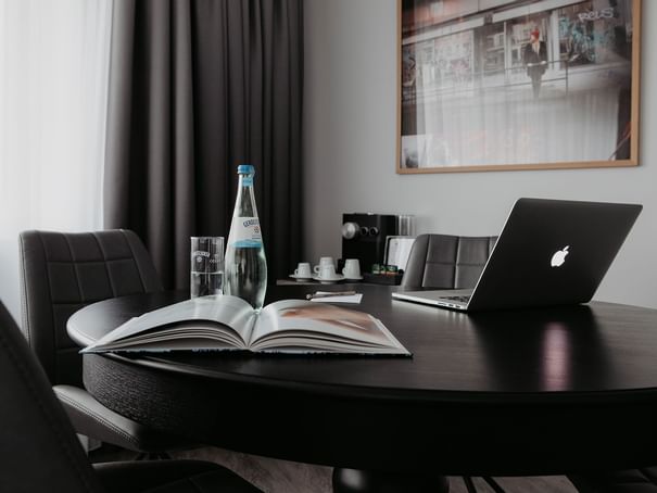 Close-up of a laptop & book on a table at Hotel Berlin Berlin