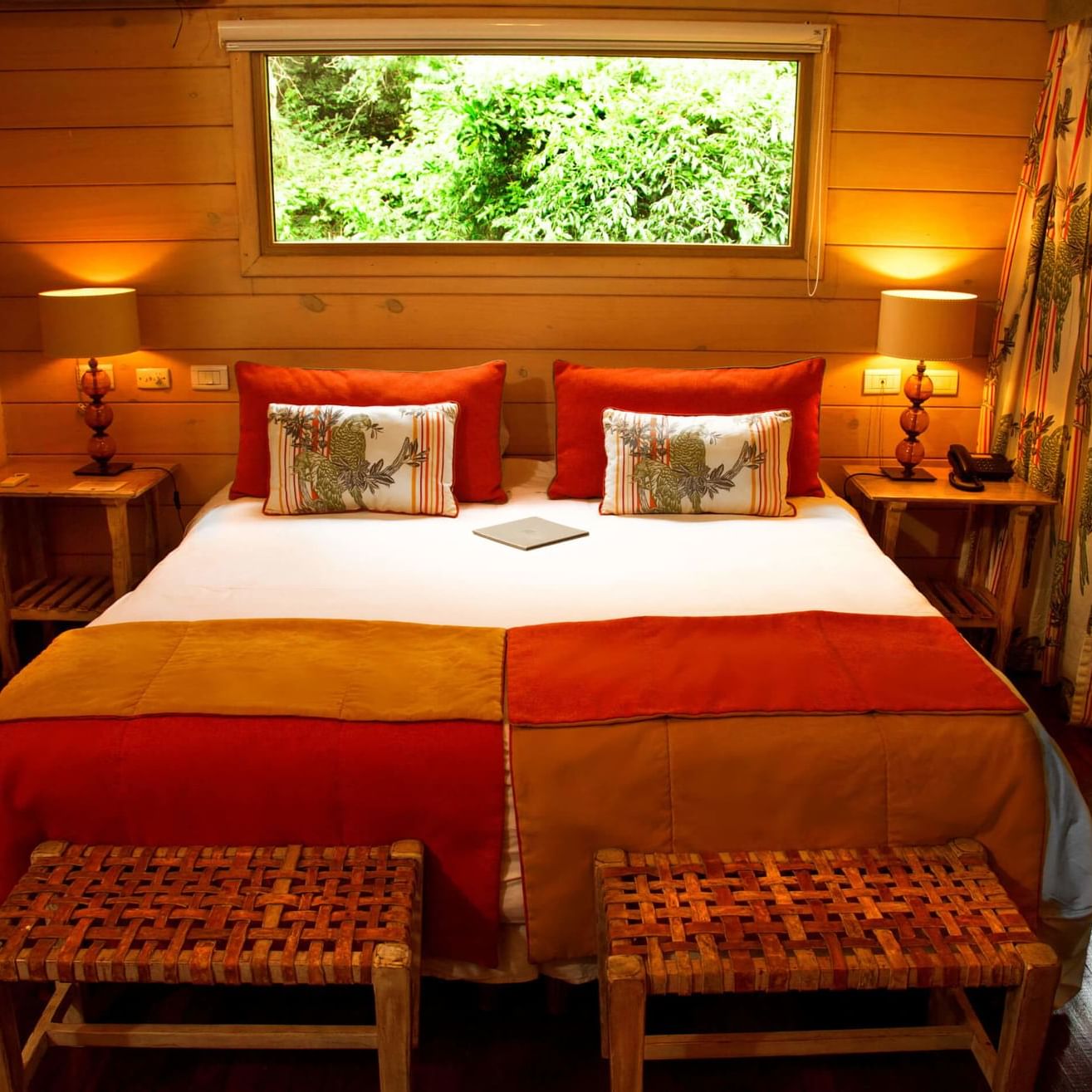 Close up of a king bed in a room at La Cantera Lodge de Selva 