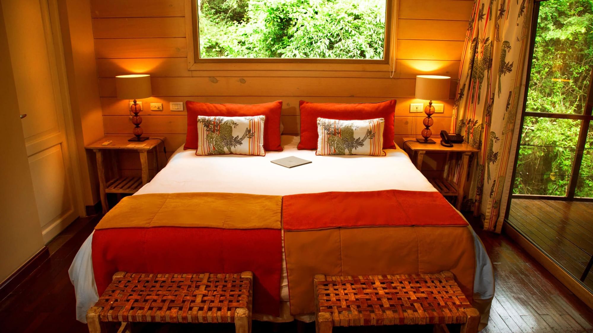 Bed & furniture in the jungle room at DOT Hotels