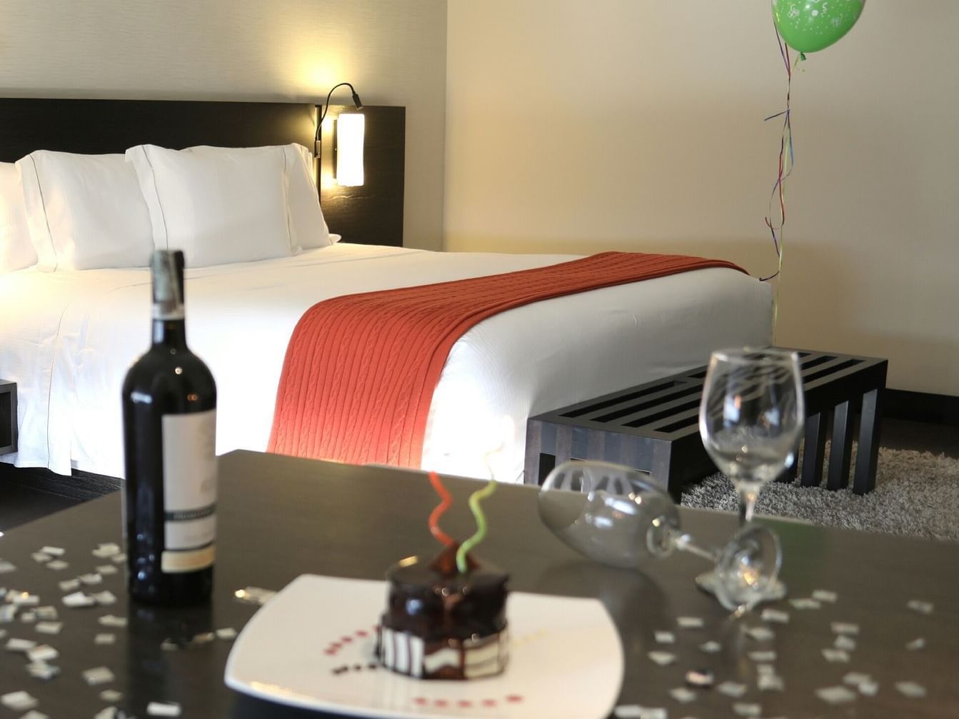 birthday celebration with cake and wine in room