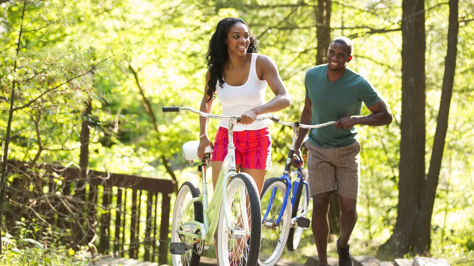 Couple with their cycles on a trail, while exploring the surrounding near Cove Pocono Resorts