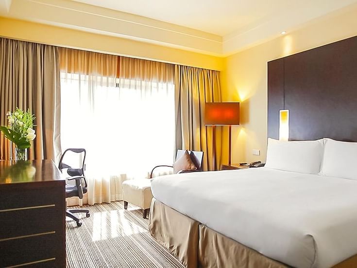 Executive room interior with large bed at Amara Hotel Singapore