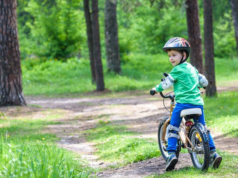 A Toddler riding a bicycle at Curamoria Collection