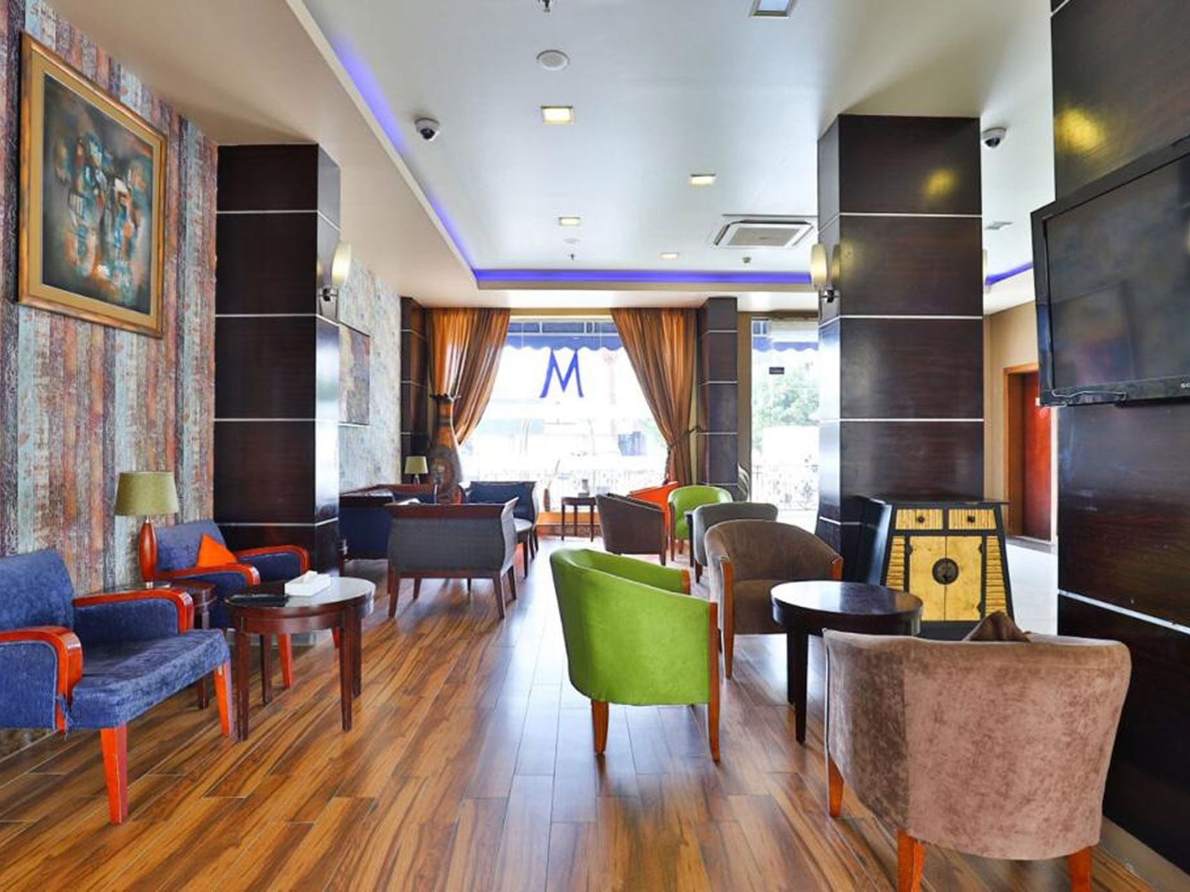 A lounge area with fancy chairs at Mena Plaza Taif