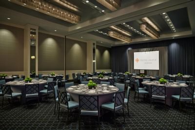 a large grand ballroom with chairs and tables