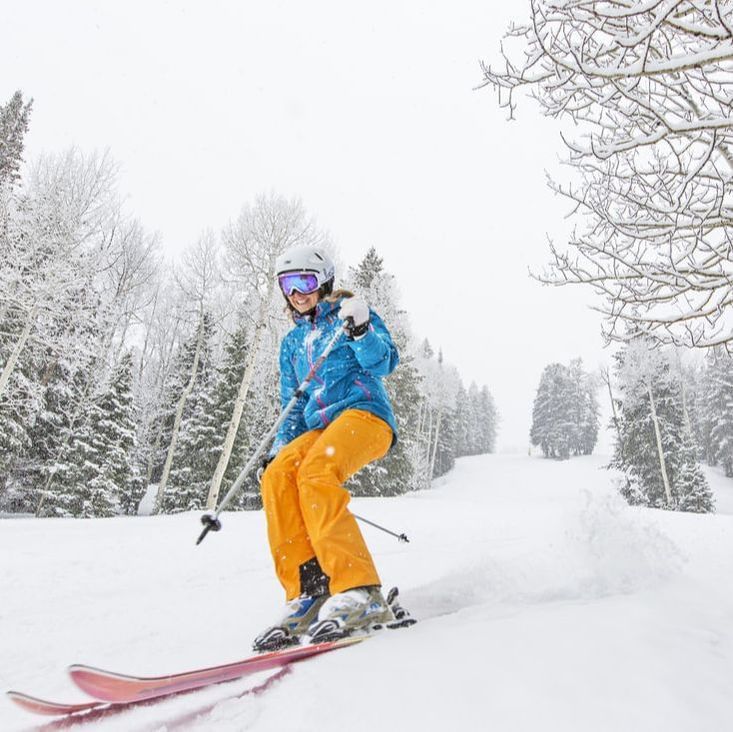 Close-up on a female skier skiing downhill near Stein Lodge