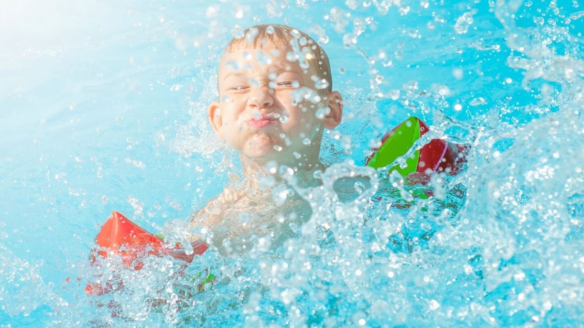 Happy kid boy having fun in a pool at Village Hotels Blackpool