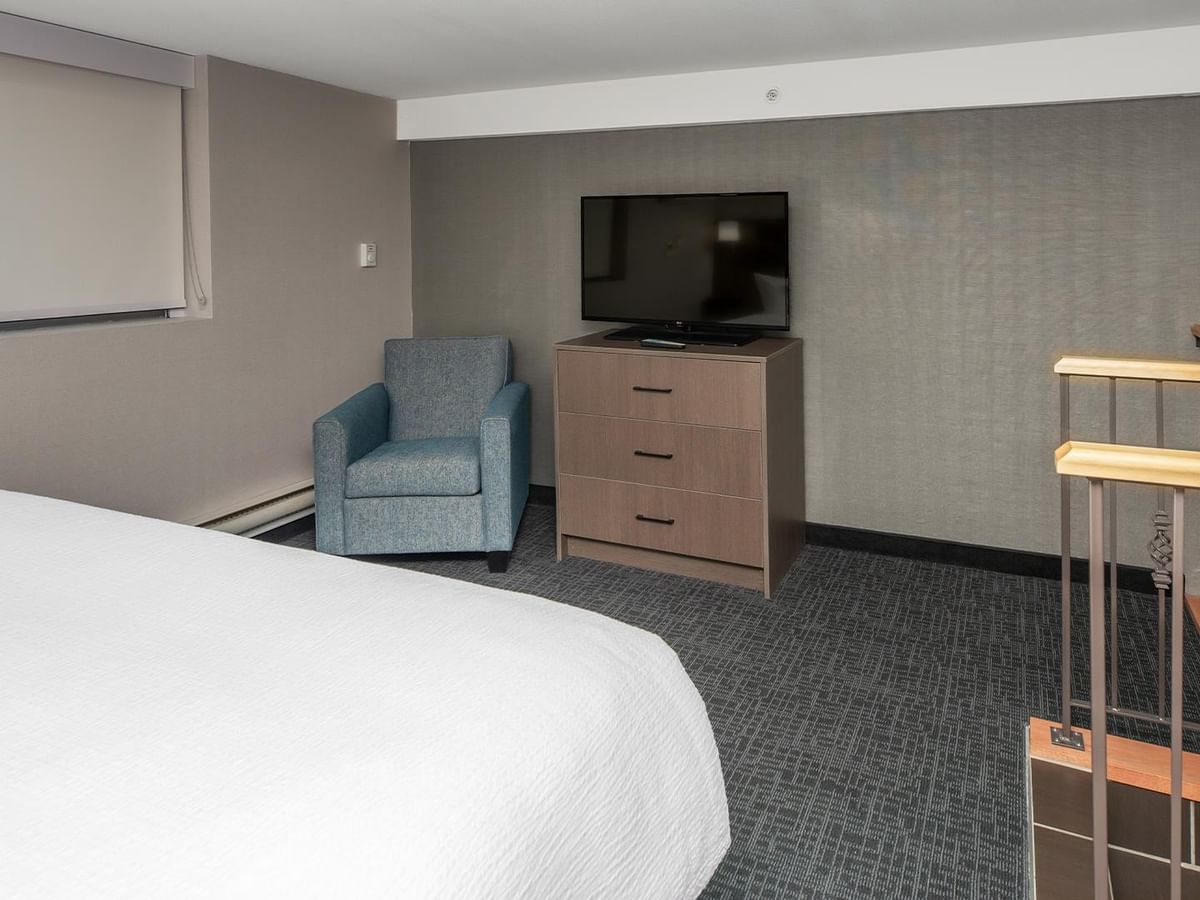 King bed, chair, and TV.