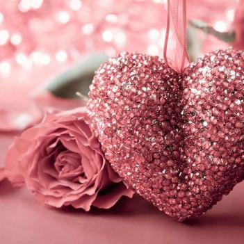 Sparkling pink heart ornament next to a pink rose at The Saujana Hotel Kuala Lumpur