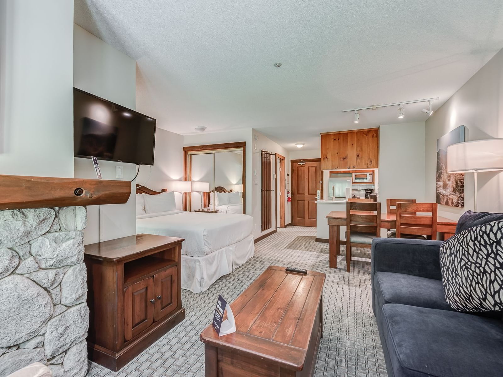 Dining table & TV lounge area by the bed in Studio at Blackcomb Springs Suites