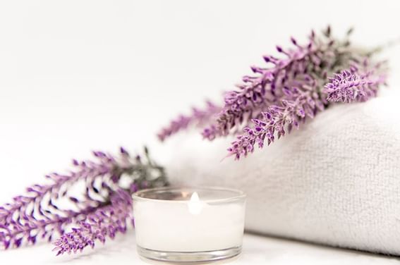 Close-up of a burning spa candle and lavender at Abidah Hotel