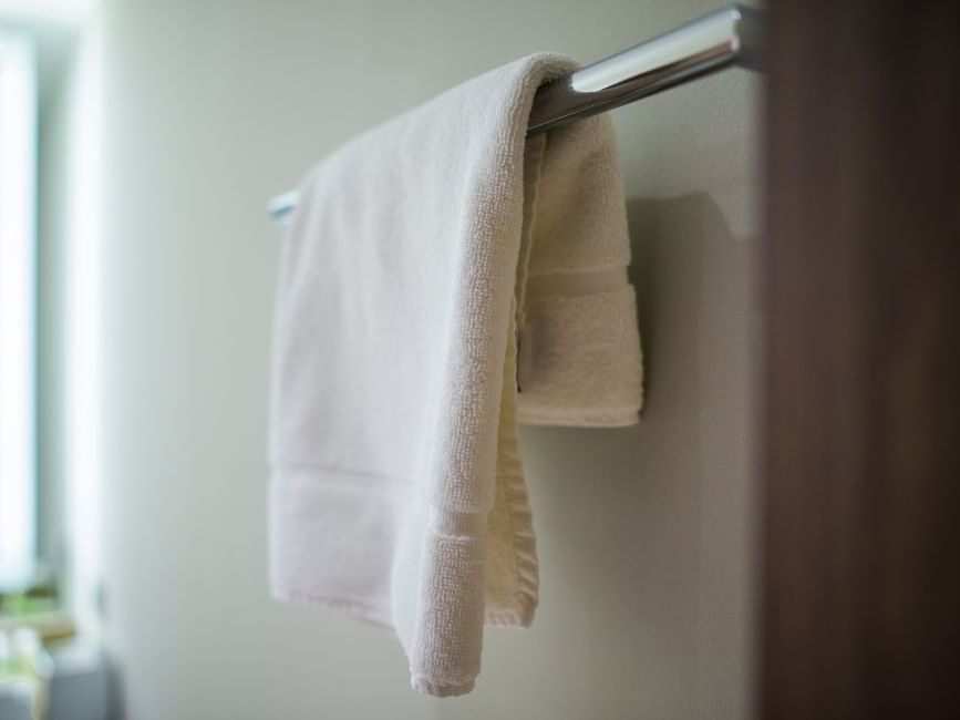 Close-up of towel hung on a rack in a bathroom at Brady Hotels Jones Lane
