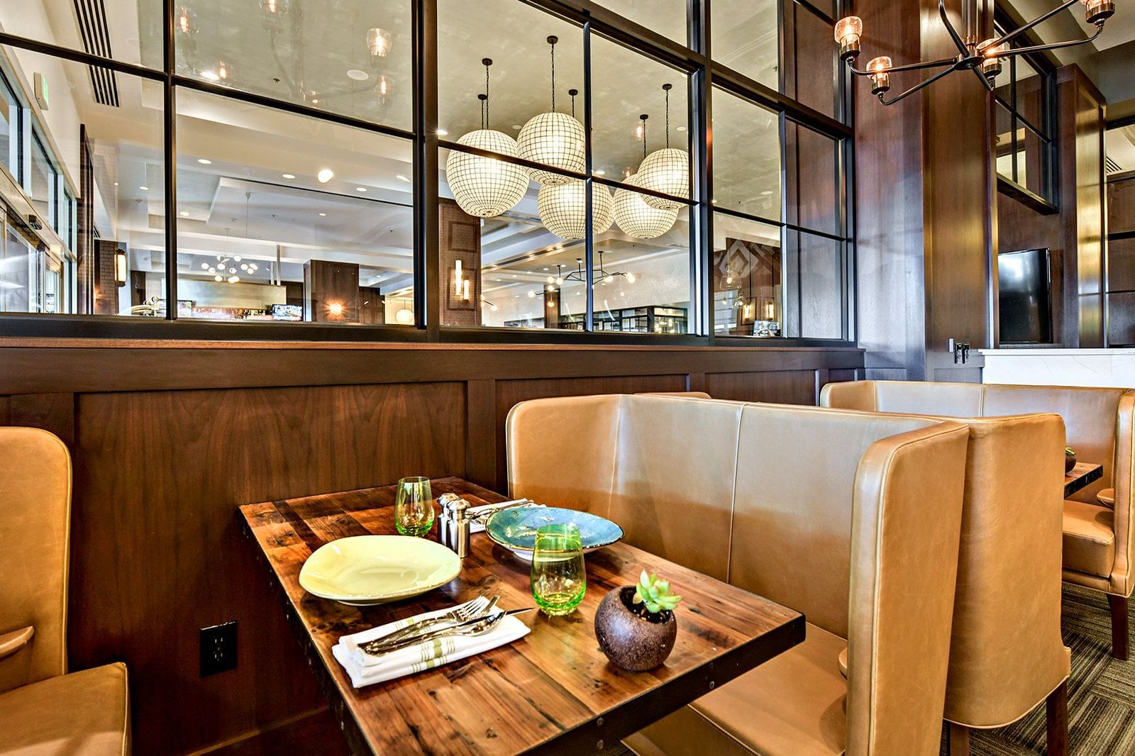 A booth in a dining area in Trillium Restaurant at Grove Hotel