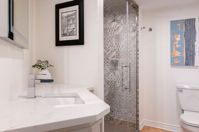 Bathroom with vanity & shower area in Superior Loft at Retro Suites Hotel