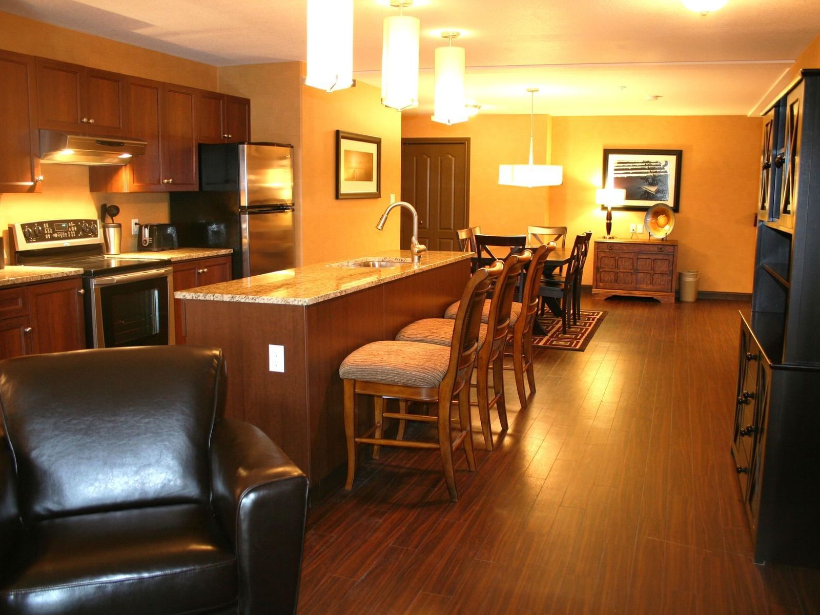 chairs and a kitchen in a hotel room