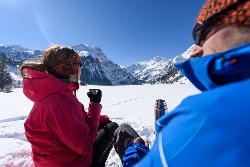 A couple at Tannheimer valley near Liebes Rot Flueh in winter