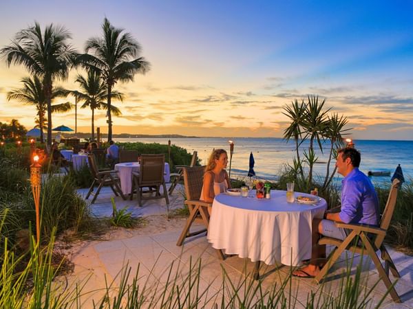 Couple having evening Outdoor dine-in at Windsong Resort On The Reef