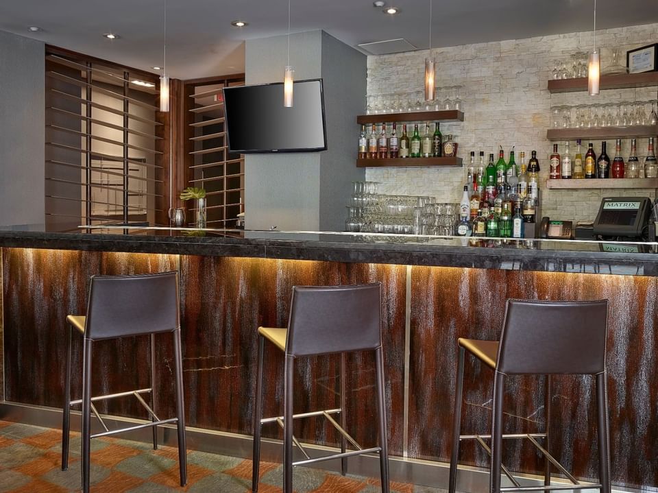 Interior of the bar counter with three chairs at Matrix Hotel