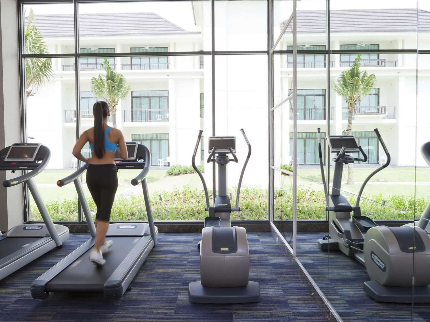 Lady running on treadmill at Gym at U Hotels and Resorts