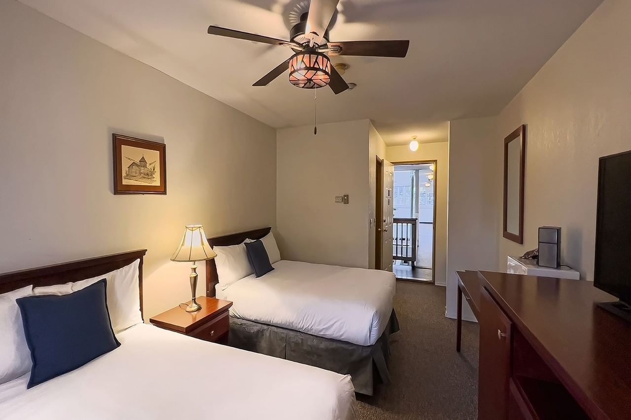 Guest room with two beds and desk