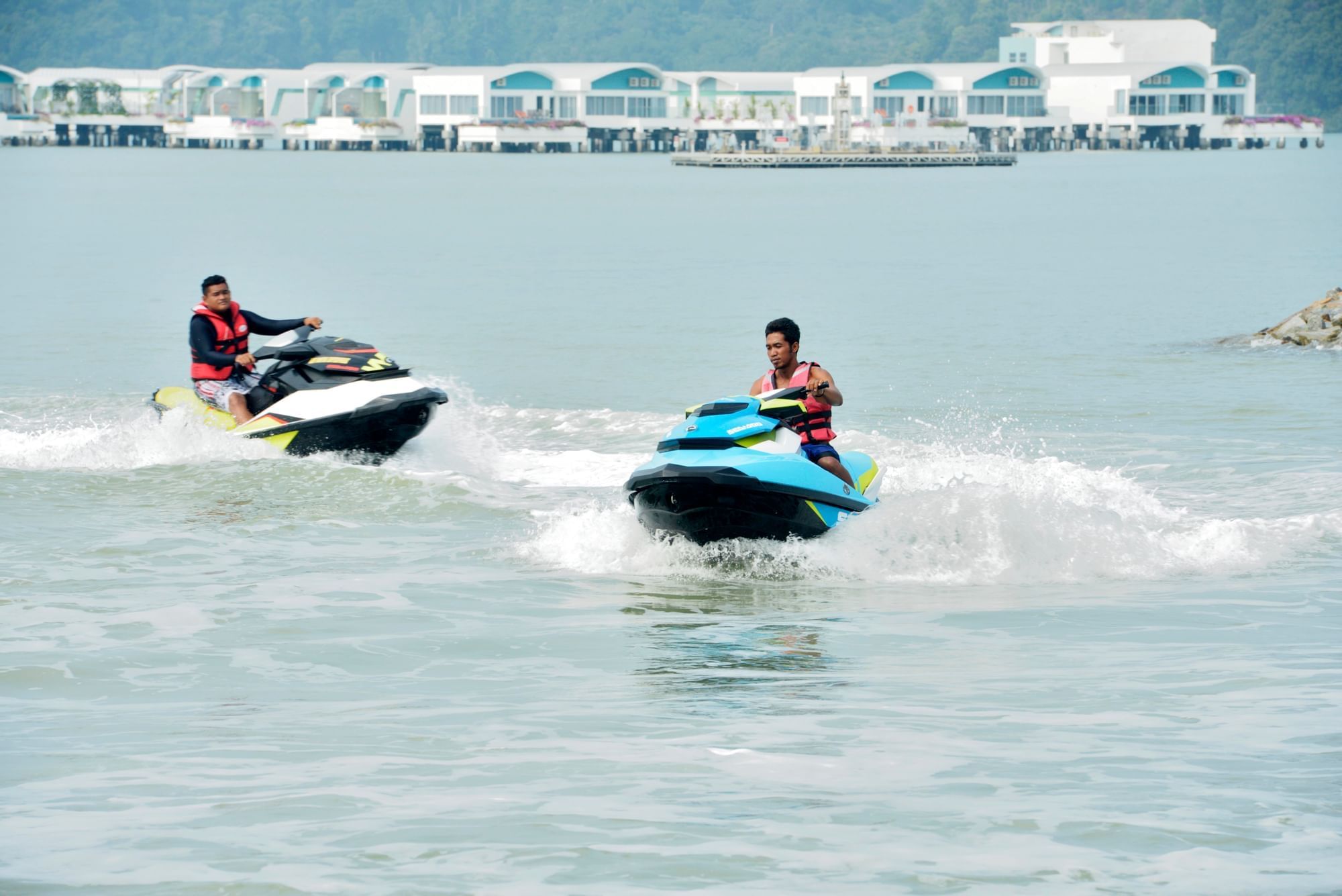 Two men playing jet ski on sea - Lexis Hibiscus