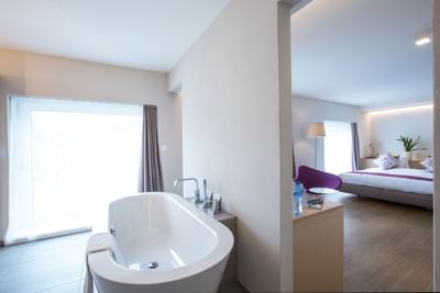 Bathtub & bedroom in Junior suite at Best Western Spirgarten​​