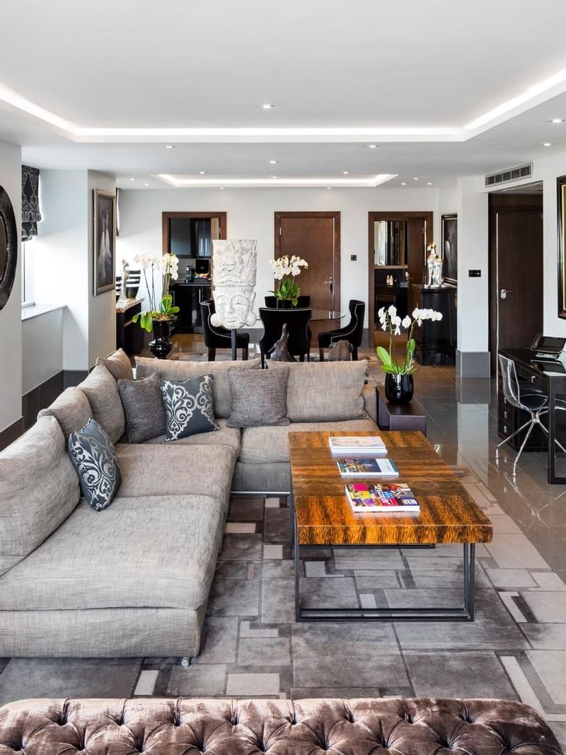A Lounge area with a Tv at The May Fair Hotel London