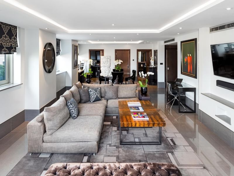 A Lounge area with a Tv at The May Fair Hotel London