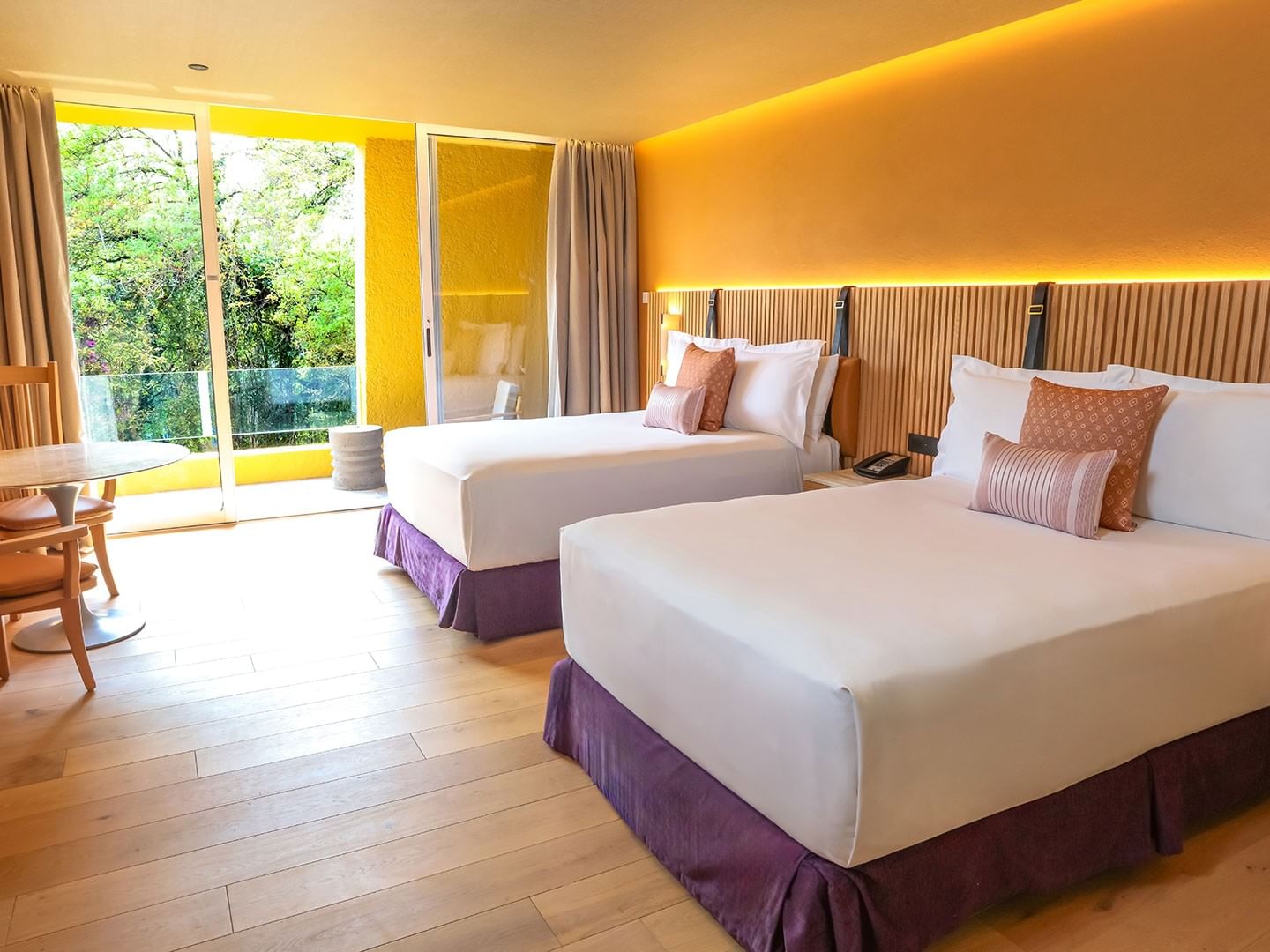 2 Double Superior Camino Real Club Garden View with two beds, orange walls, and a balcony at Camino Real Polanco Mexico