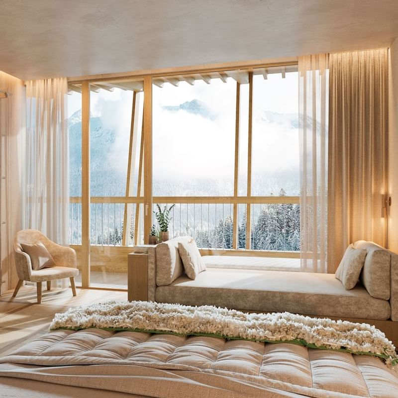Bed & lounger in a room at Falkensteiner Hotels