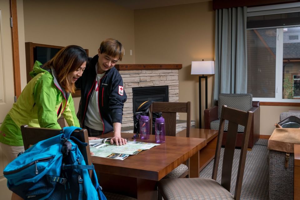 A couple looking at a map in a room at Falcon Crest Lodge