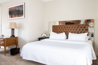 Cozy large bed and nightstand in Apartment 301 at Retro Suites Hotel