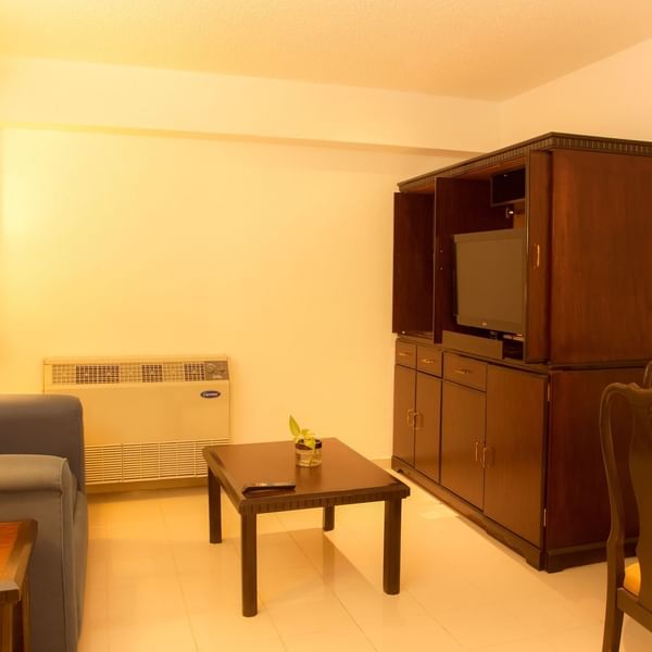 Interior of a room with a lounge area and TV at Fiesta Inn