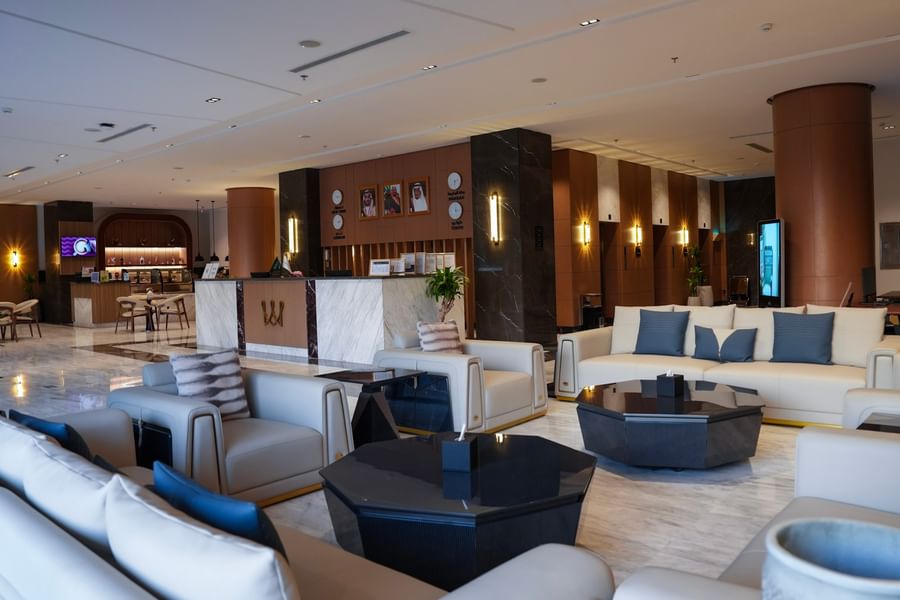 Lobby with beige couches, coffee tables, and a reception desk at Warwick Hotel & Spa - Jeddah.