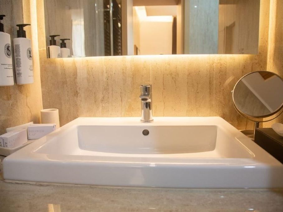 Sink & mirror in bathroom of Classic Room at Rome Luxury Suites
