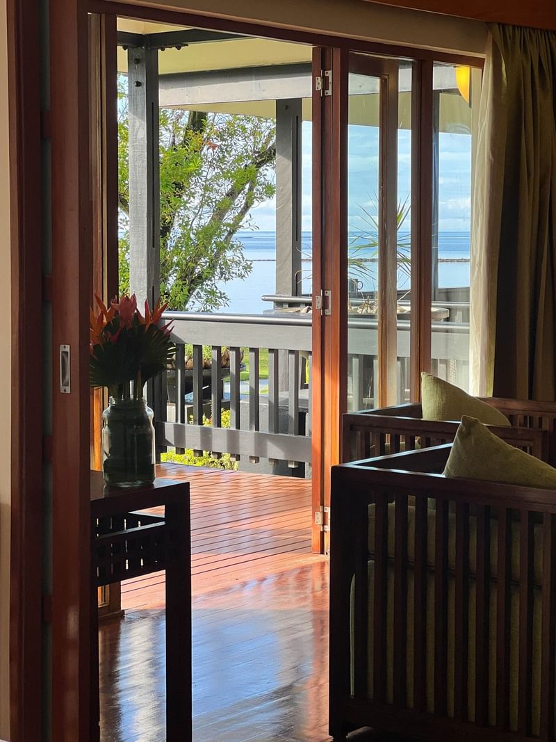 Open doors to a wooden deck with ocean view at The Naviti Resort in Korolevu.