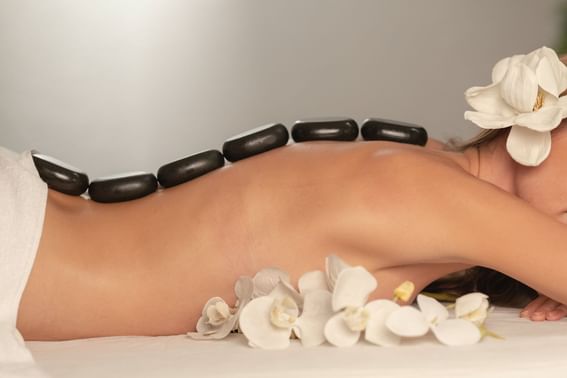 Lady having a hot stone massage in the Spa at Po Hotel Semarang