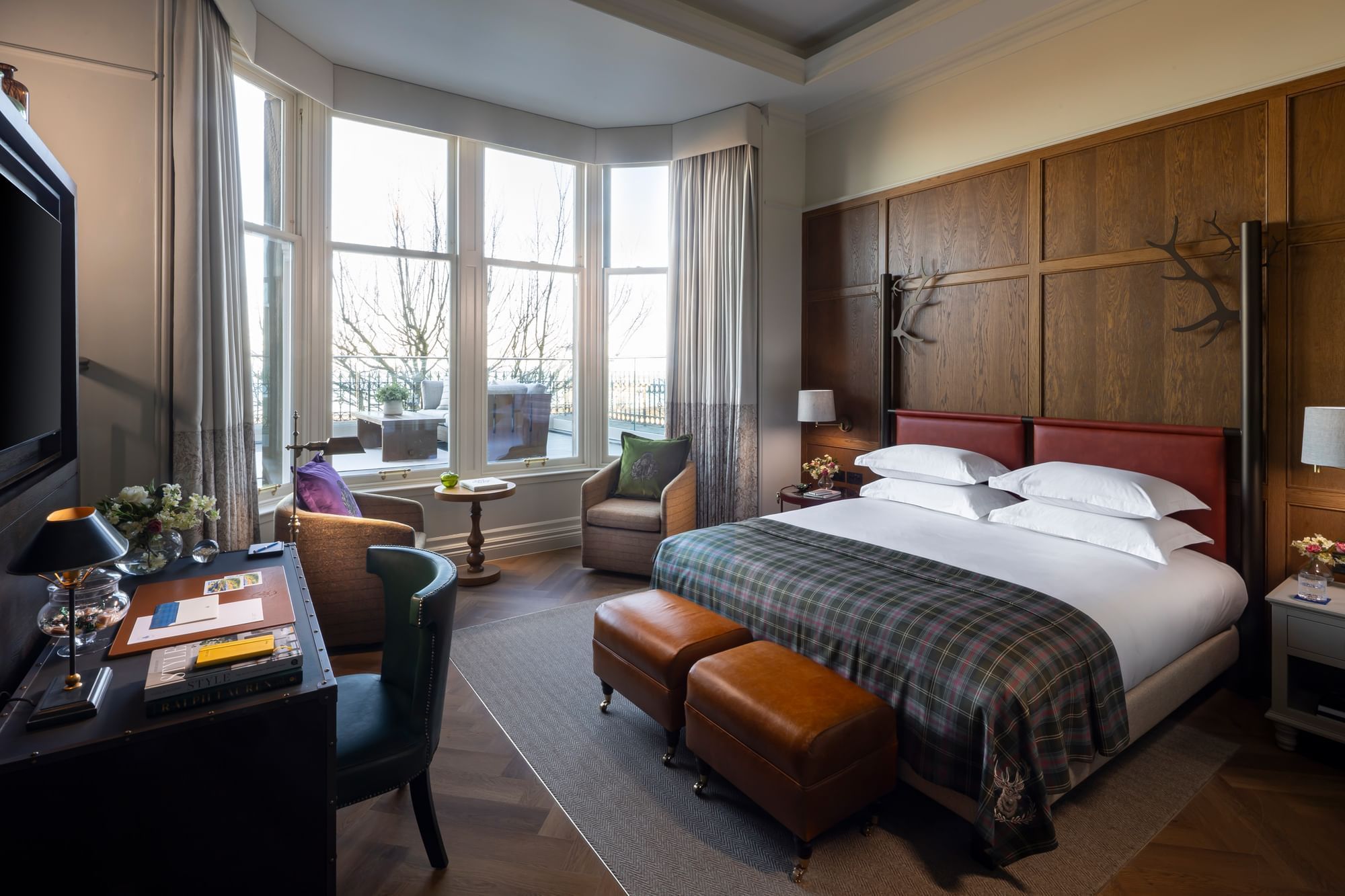 Suite with Sea View & Terrace, with a king bed, a plaid throw, and a desk next to a large bay window at Seaton House