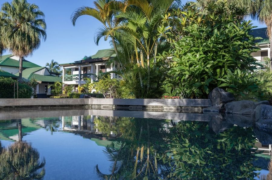 Swimming pool with lush greenery and resort buildings at Tokatoka Resort - Fiji International Airport.